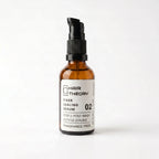 Hair Theory Fiber Sealing Serum, a 50 ml fragrance-free post-wash serum in an amber glass bottle with a black pump.