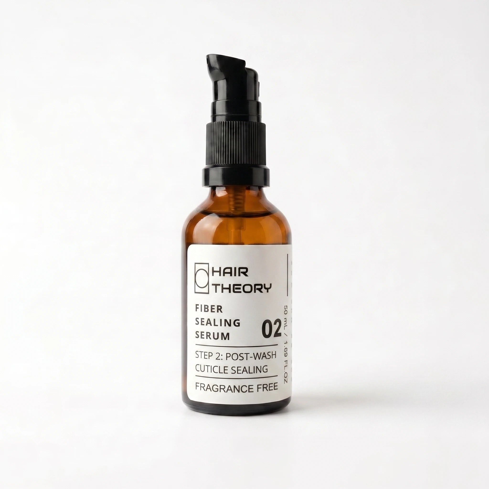 Hair Theory Fiber Sealing Serum, a 50 ml fragrance-free post-wash serum in an amber glass bottle with a black pump.